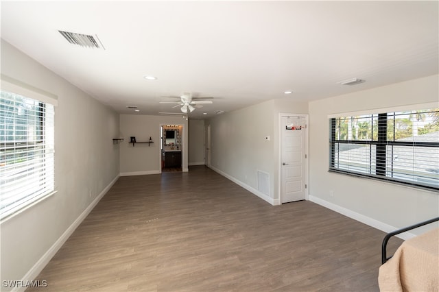 unfurnished room featuring ceiling fan, hardwood / wood-style flooring, and plenty of natural light