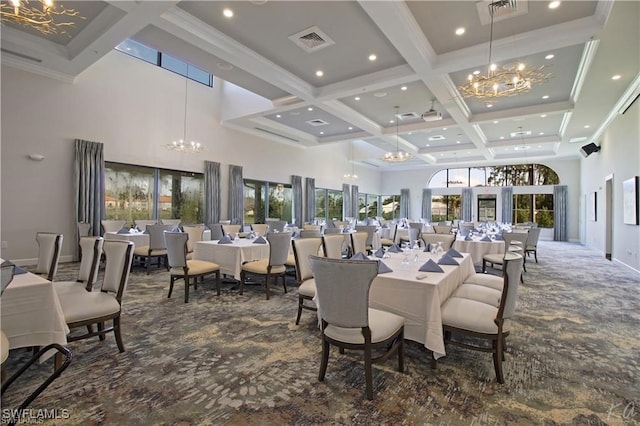 carpeted dining room with a towering ceiling, beamed ceiling, a chandelier, ornamental molding, and coffered ceiling