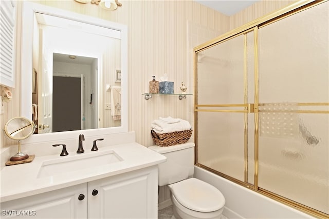 full bathroom with vanity, shower / bath combination with glass door, and toilet