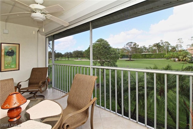 sunroom featuring ceiling fan