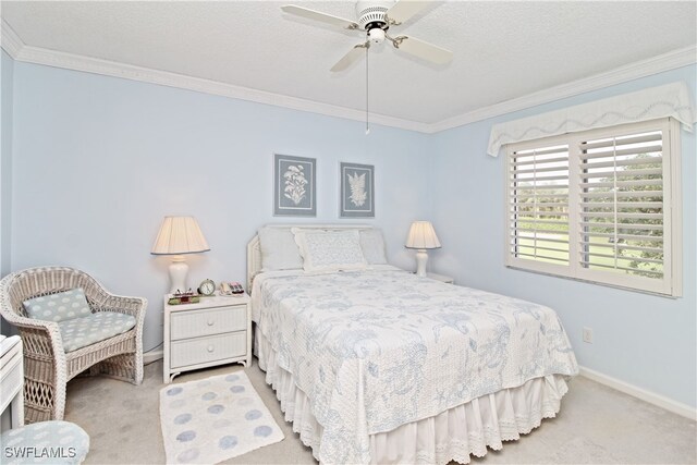 bedroom with ornamental molding, light colored carpet, ceiling fan, and a textured ceiling