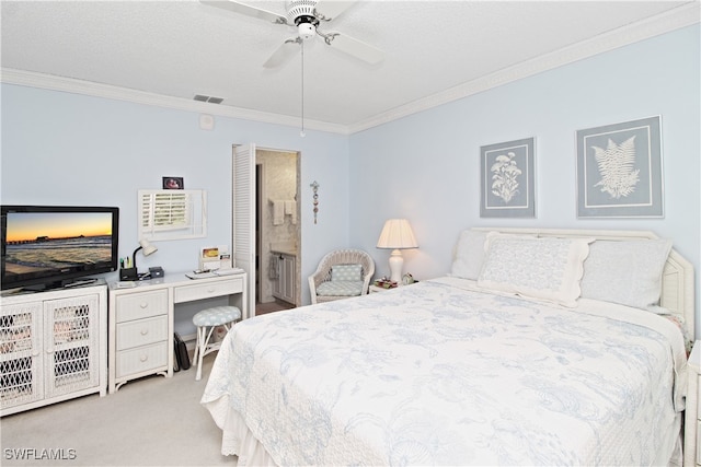 carpeted bedroom featuring crown molding, ceiling fan, and ensuite bathroom