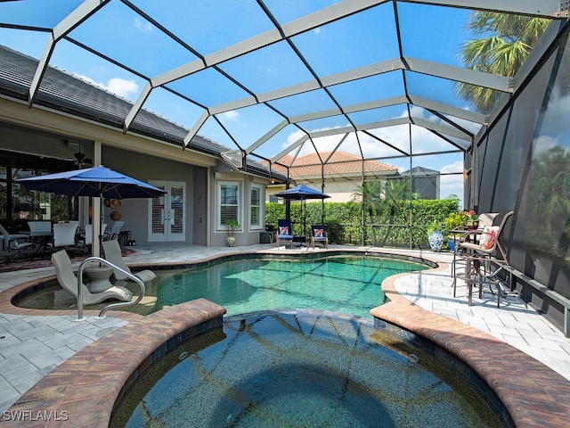 view of pool with an in ground hot tub, a patio, and a lanai