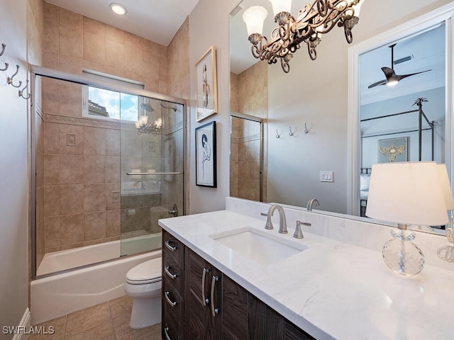 full bathroom with shower / bath combination with glass door, toilet, ceiling fan with notable chandelier, vanity, and tile patterned flooring