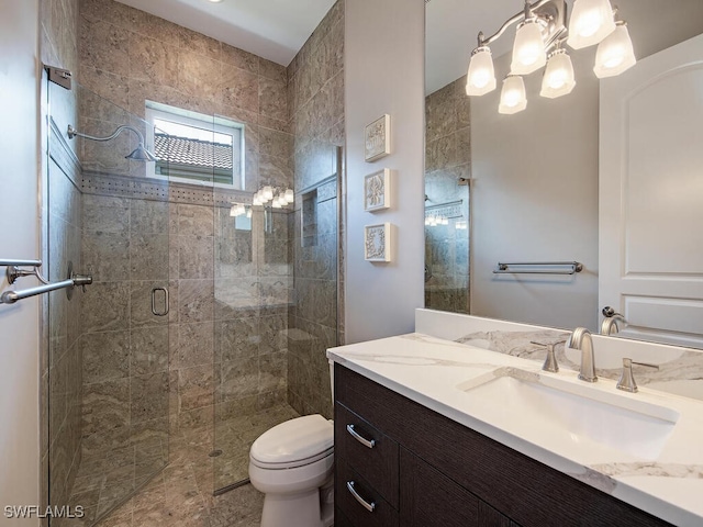 bathroom with vanity, toilet, and walk in shower