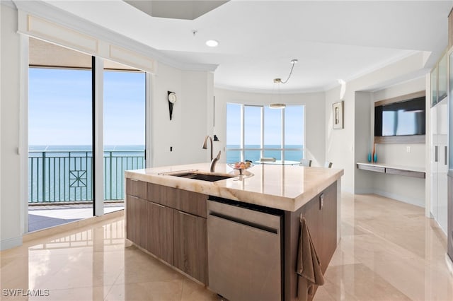 kitchen featuring sink, a water view, ornamental molding, an island with sink, and stainless steel dishwasher