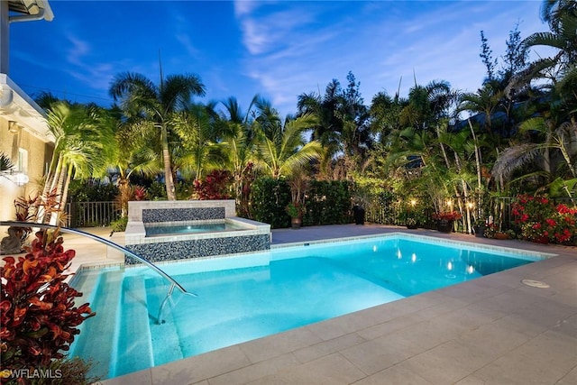 view of swimming pool with an in ground hot tub