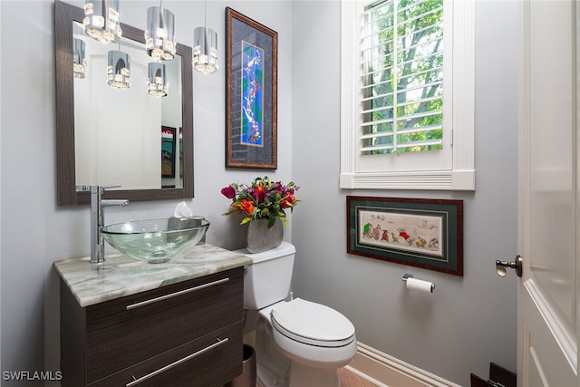 bathroom featuring vanity and toilet