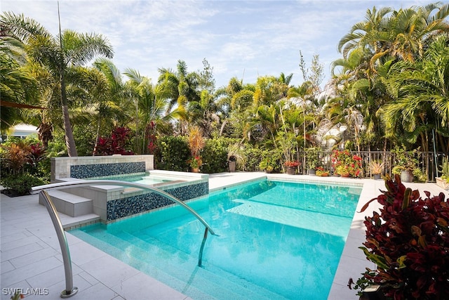 view of pool with an in ground hot tub