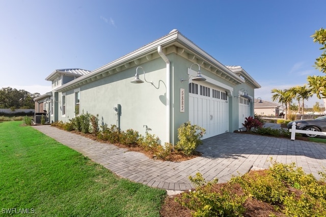 view of home's exterior with a yard and a garage