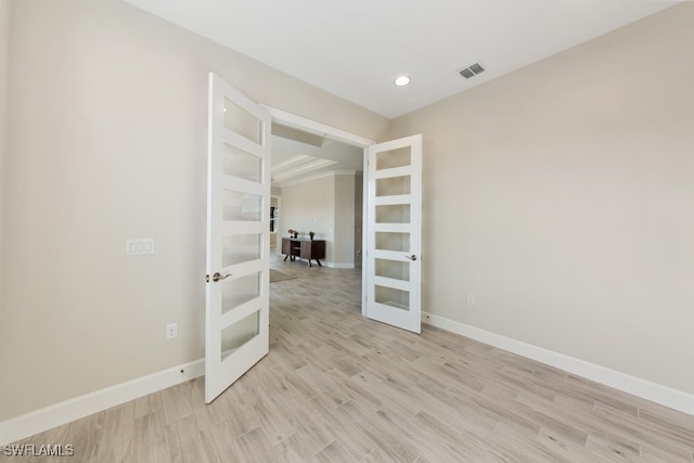 unfurnished room with light hardwood / wood-style flooring and french doors