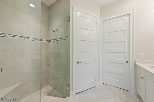 bathroom with vanity and a shower with shower door