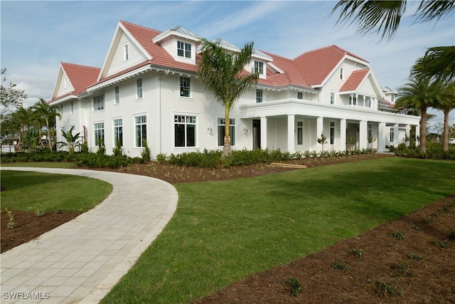 back of house featuring a yard and covered porch