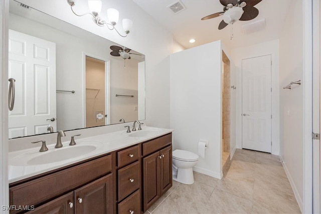 bathroom with vanity, a shower, tile patterned flooring, ceiling fan, and toilet