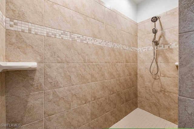 bathroom with a tile shower