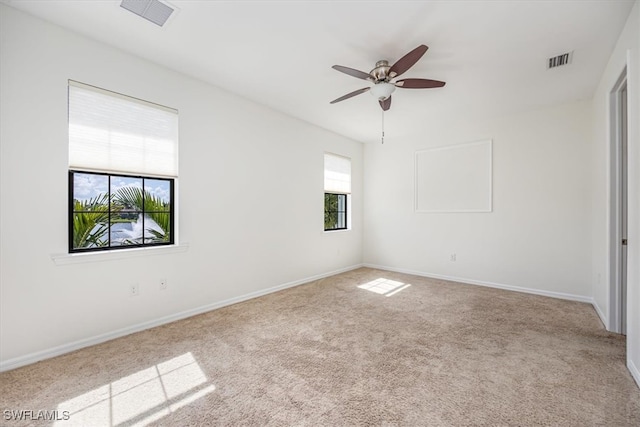 unfurnished room featuring light carpet and ceiling fan