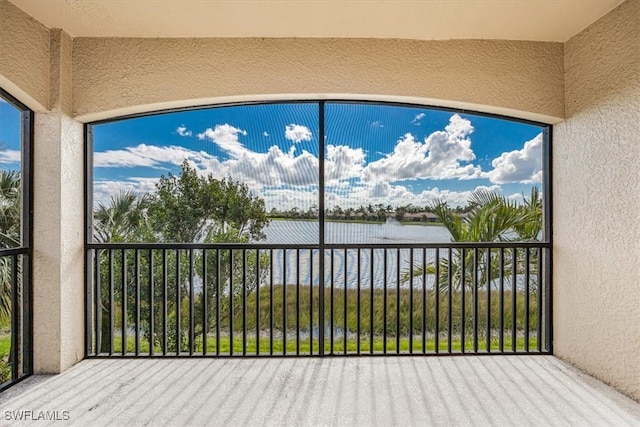 unfurnished sunroom with a water view