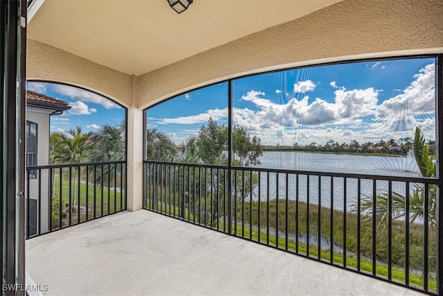 unfurnished sunroom featuring a water view