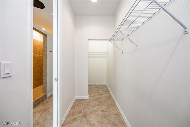 spacious closet featuring light tile patterned floors