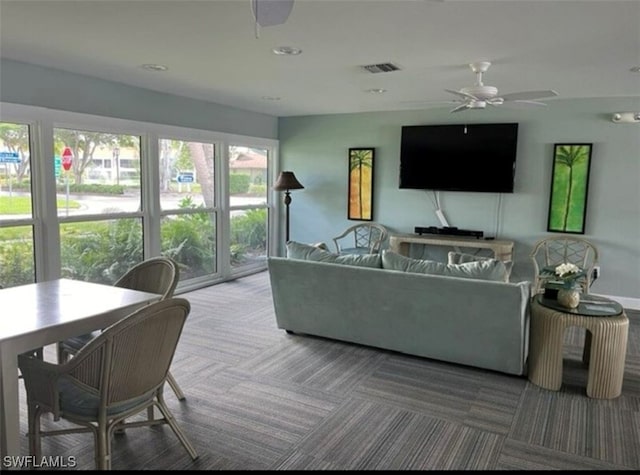 carpeted living room featuring ceiling fan