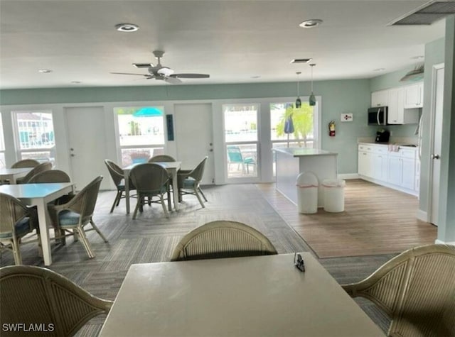 dining area featuring ceiling fan and light hardwood / wood-style flooring