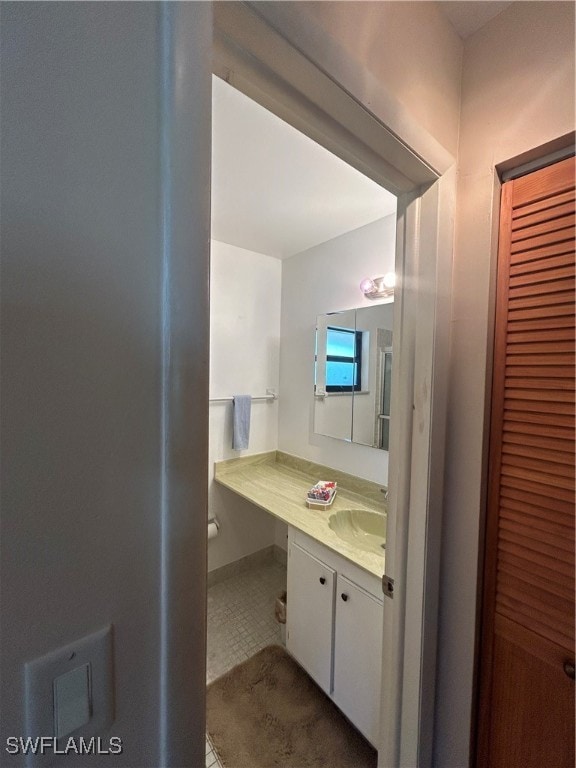 bathroom with tile patterned flooring and vanity