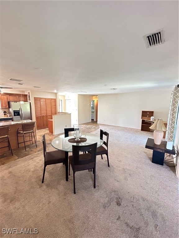 dining room featuring light colored carpet