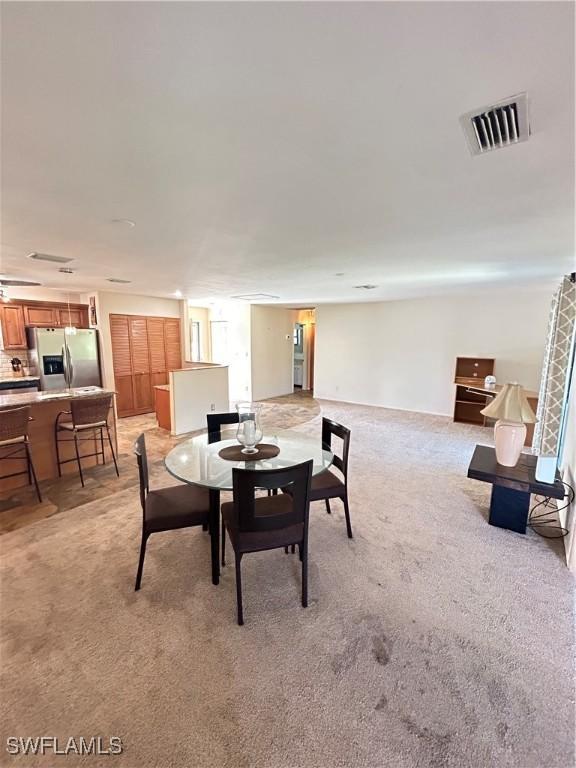 4301 Island Cir Unit 2, Fort Myers, FL 33919 - dining room with light carpet