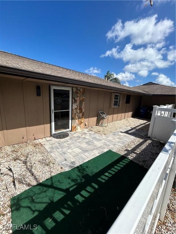 4301 Island Cir Unit 2, Fort Myers, FL 33919 - back of house featuring board and batten siding, a patio area, and stone siding