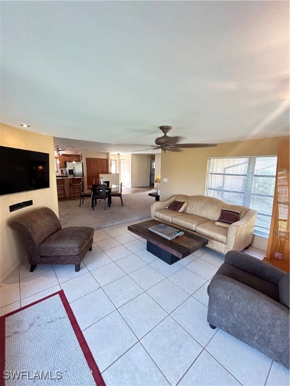 tiled living room featuring ceiling fan