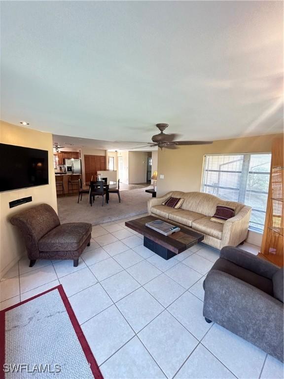 4301 Island Cir Unit 2, Fort Myers, FL 33919 - living room featuring ceiling fan, light tile patterned flooring, and light colored carpet