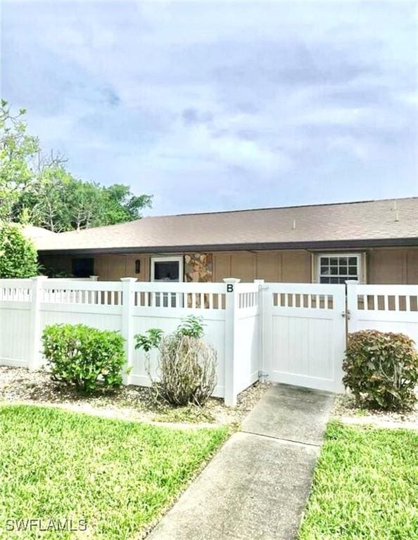 4301 Island Cir Unit 2, Fort Myers, FL 33919 - view of home's exterior with a fenced front yard and a gate