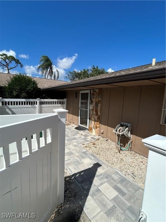 4301 Island Cir Unit 2, Fort Myers, FL 33919 - property entrance featuring a patio and board and batten siding