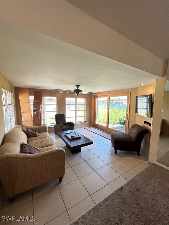 living room with ceiling fan and light tile patterned flooring