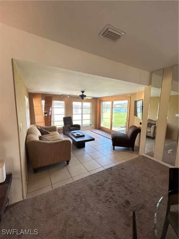 living room with ceiling fan and light tile patterned floors