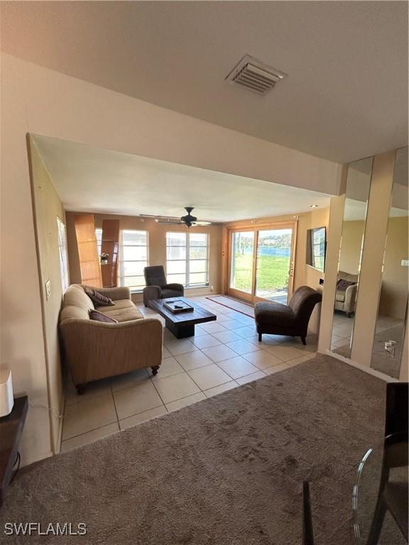 4301 Island Cir Unit 2, Fort Myers, FL 33919 - living room featuring tile patterned flooring, carpet flooring, and a ceiling fan