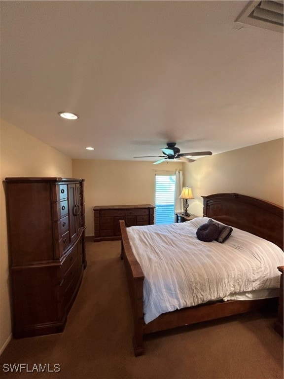 bedroom with ceiling fan and dark carpet