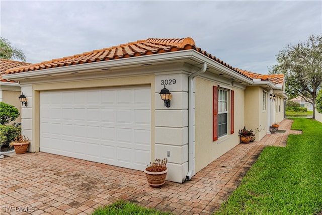 view of side of property with a garage