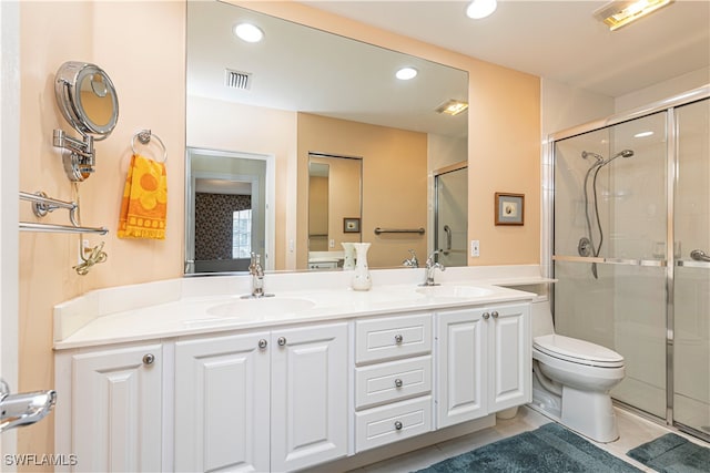 bathroom featuring tile patterned floors, vanity, toilet, and walk in shower