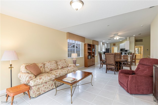 living room featuring light tile patterned floors and ceiling fan