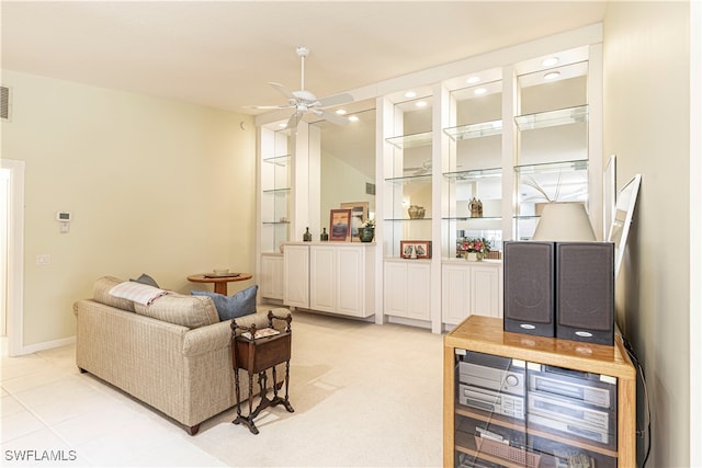 tiled living room with ceiling fan