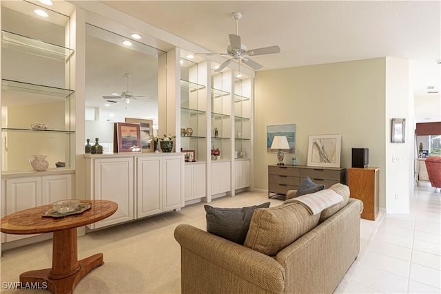 tiled living room featuring ceiling fan