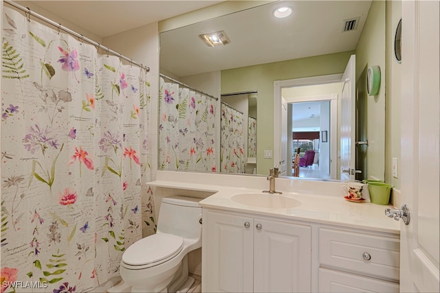 bathroom with vanity, toilet, and curtained shower