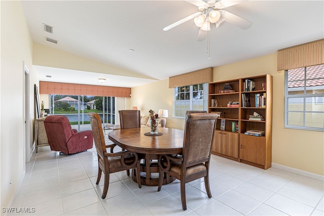 dining room with light tile patterned floors, vaulted ceiling, and ceiling fan