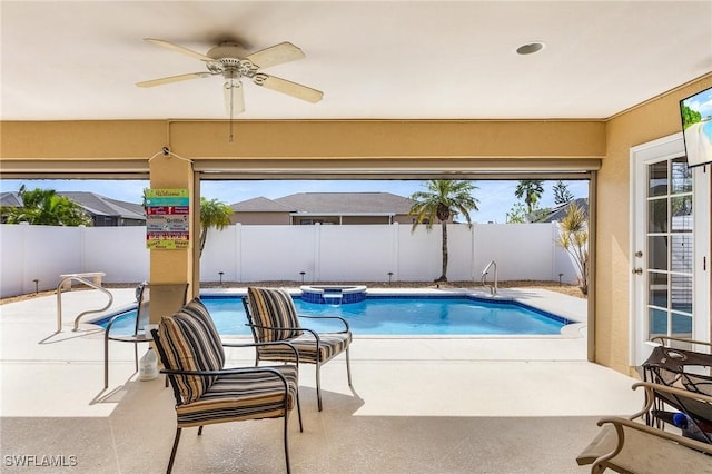 view of swimming pool featuring ceiling fan, an in ground hot tub, and a patio