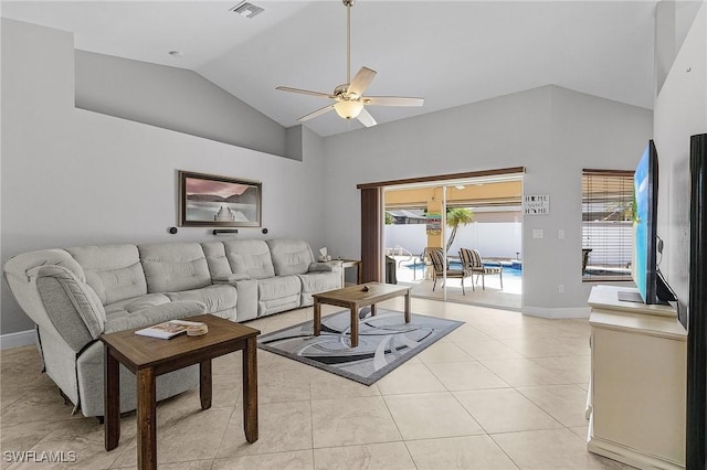 living room with ceiling fan, light tile patterned flooring, a healthy amount of sunlight, and vaulted ceiling