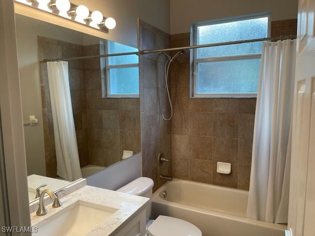 full bathroom with toilet, vanity, and shower / tub combo