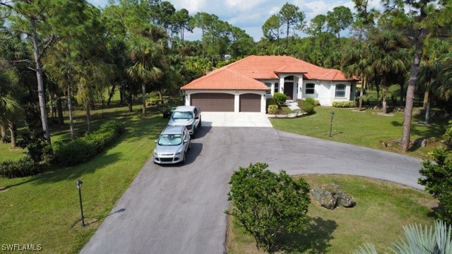 mediterranean / spanish house with a front lawn