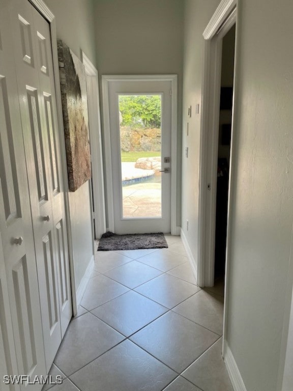 doorway with light tile patterned floors