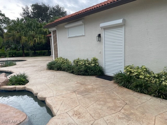 view of side of property featuring a patio area